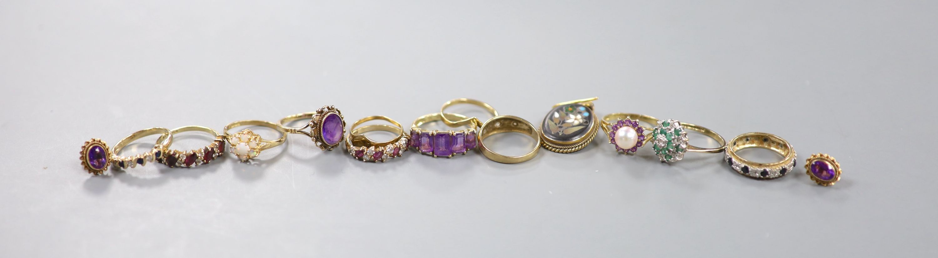 Twelve assorted modern mainly 9ct gold and gem set dress ring, a pair of 9ct and gem set earrings and a pietra dura set yellow metal earring, gross weight 28.5 grams.